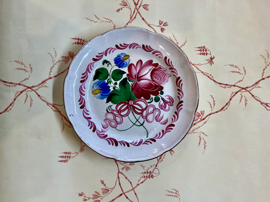 An antique French Faience floral plate circa 1800s. with flat seat, scalloped edge, polychrome decoration