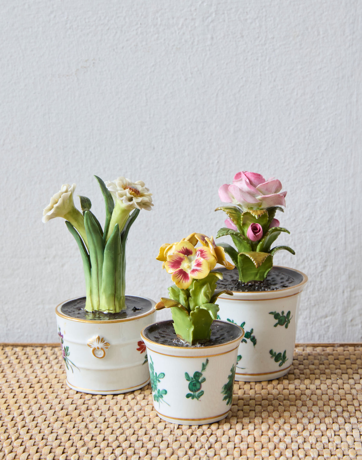 A Set of Ten Miniature Porcelain Flower Arrangements in Hand-Painted Flower Pots