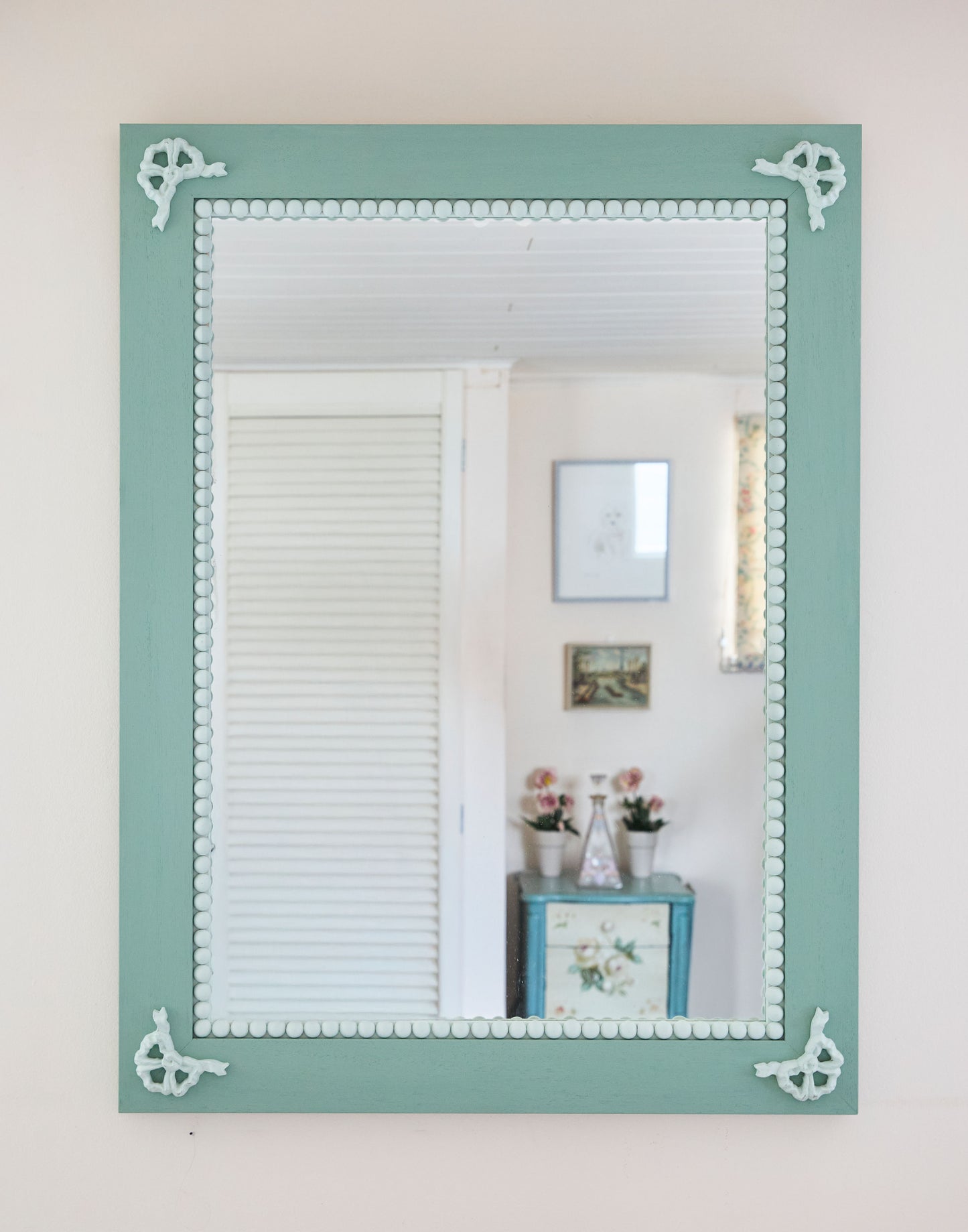 A Mirror with Bow and Bobble Decoration Handpainted in Little Greene Aquamarine Deep