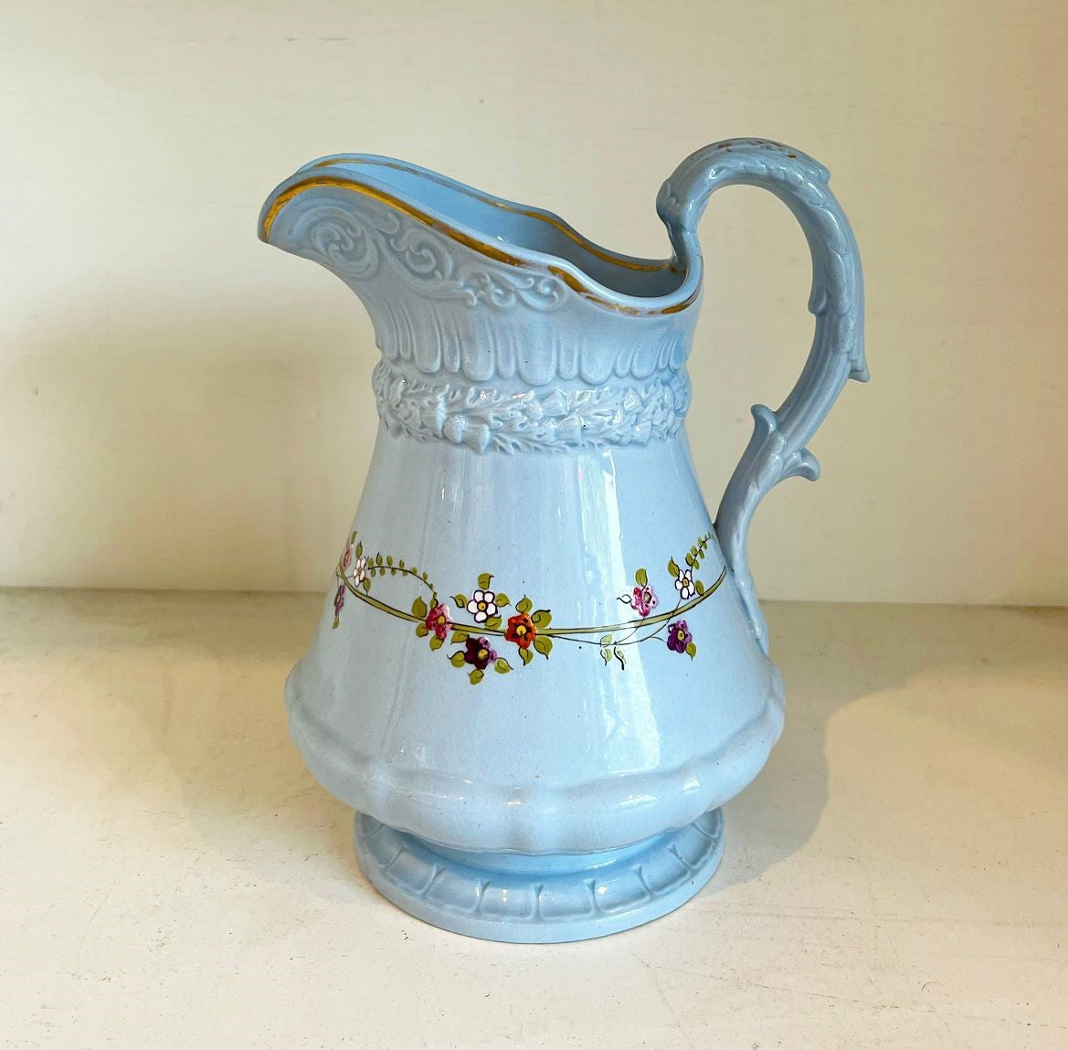 A Collection of Fifteen Pale Blue Stoneware PitcherJugs Handpainted with Flowers and Gilded Accents by William Ridgway circa 1840s