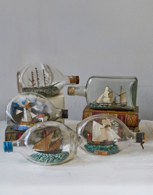 A Collection of Seven Vintage 'Ships in Bottles', each Modelled with Interior Scenes made 1950s-1970s