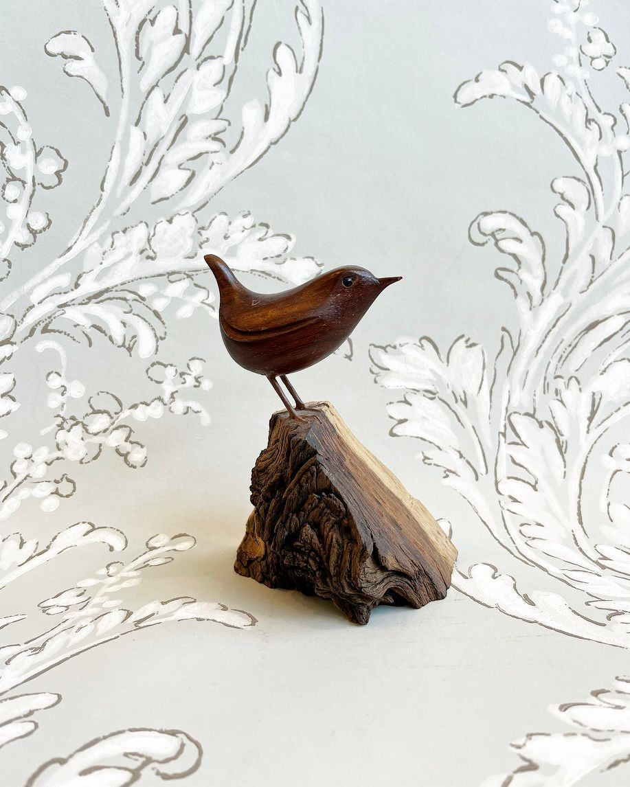 A Standing Wren Hand-Carved in Padauk Wood on a Fossil Wood Base