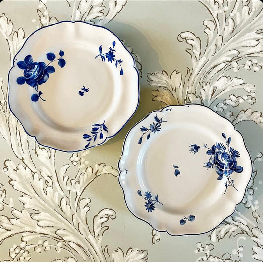 Two 18th Century Faience Rococo Plates with a Four-Pass Shaped Rim Glazed in White with Polychrome Decorated Flowers in Blue